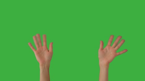 woman waving her hands over green screen