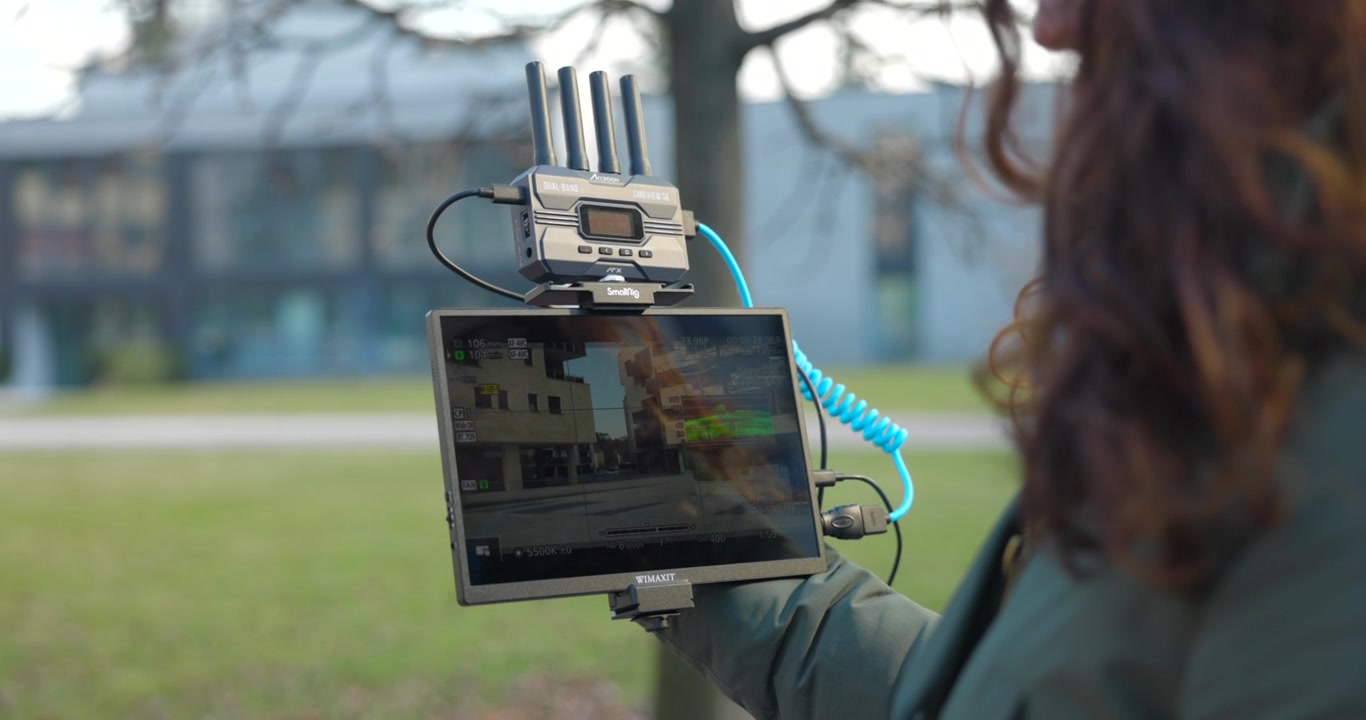Woman looks intently at the CineView SE Wimaxit monitor, videography