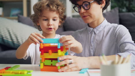 mother and child playing with building blocks