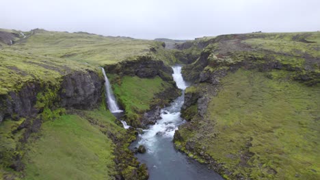 aerial high above the famous natural landmark and tourist attraction of skogafoss falls and fimmvorduhals trail in iceland