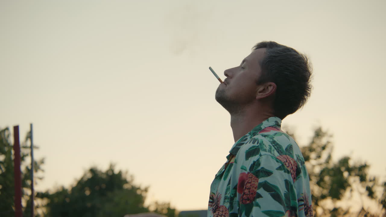 Man Smoking Cigarette at Sunset