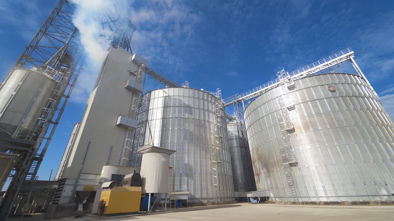 Grain elevators outdoors. Aluminum containers for storing grain. Agribusiness.