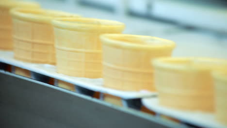 empty waffle cone on production line. food factory conveyor belt. food plant