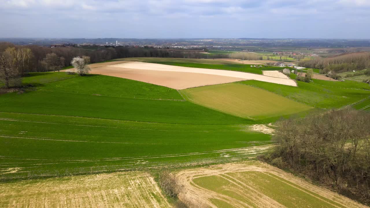 Aerial fly over Belgian agricultural fields on a cloudy day