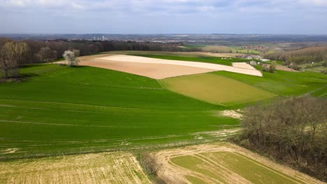 aerial fly over belgian agricultural fields on a cloudy day