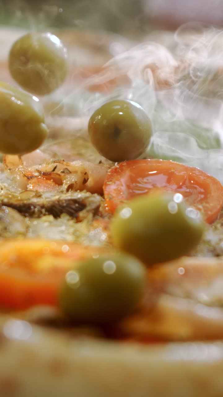Close-up of pizza with olives and tomato