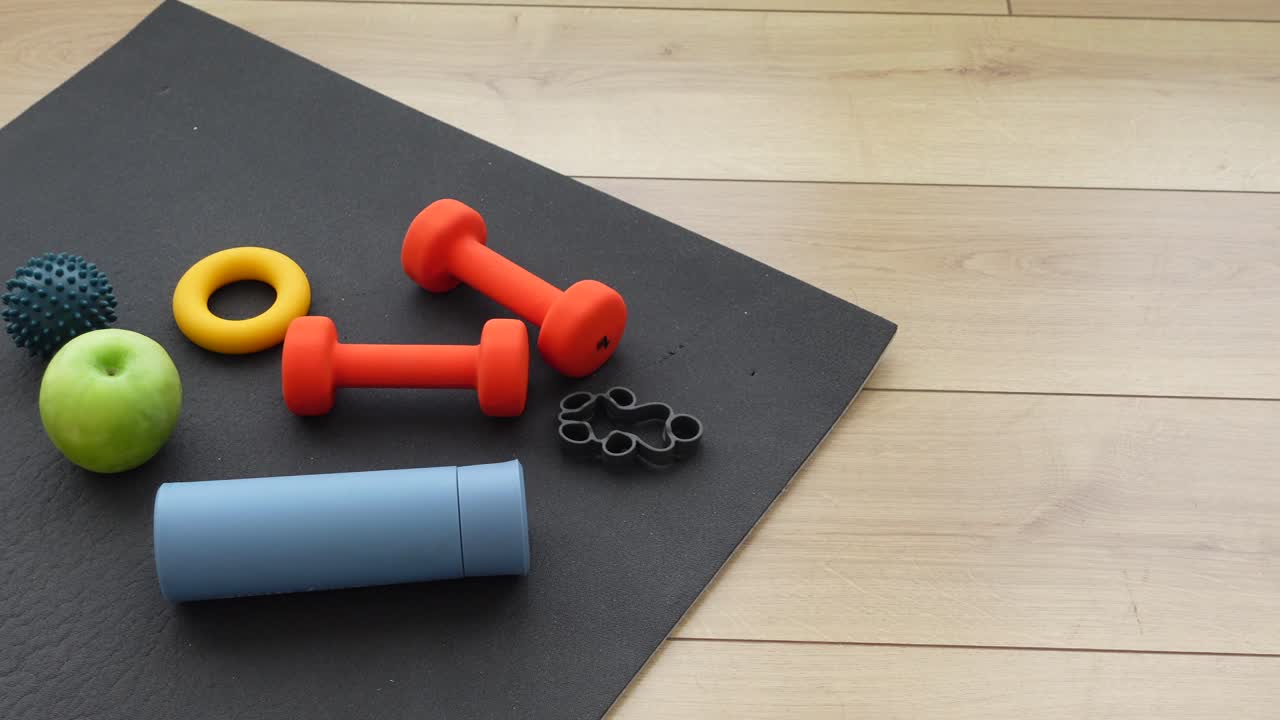 Fitness and exercise equipment on a yoga mat
