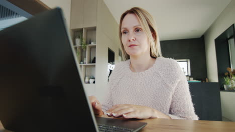 Middle-aged-woman-works-at-home,-uses-a-laptop.-Remote-work-from-home