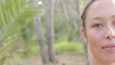 Half-of-a-young-Caucasian-woman's-face-is-visible,-with-a-backdrop-of-trees,-with-copy-space