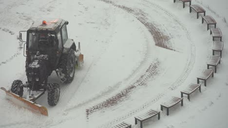 tractor vehicle cleaning the yard from the snow storm