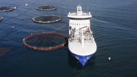 drone shot of a docked fish farm ship on a sunny day on the hebrides