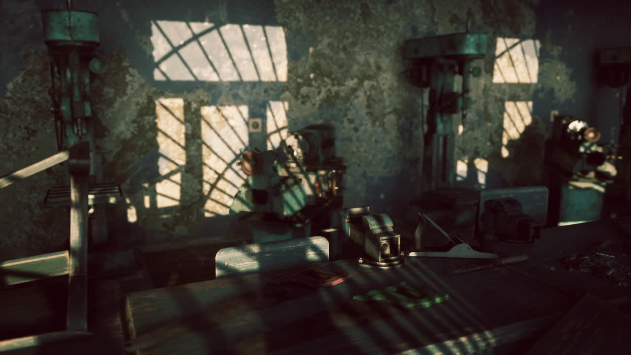 Shadows and textures inside an abandoned industrial workshop at dusk