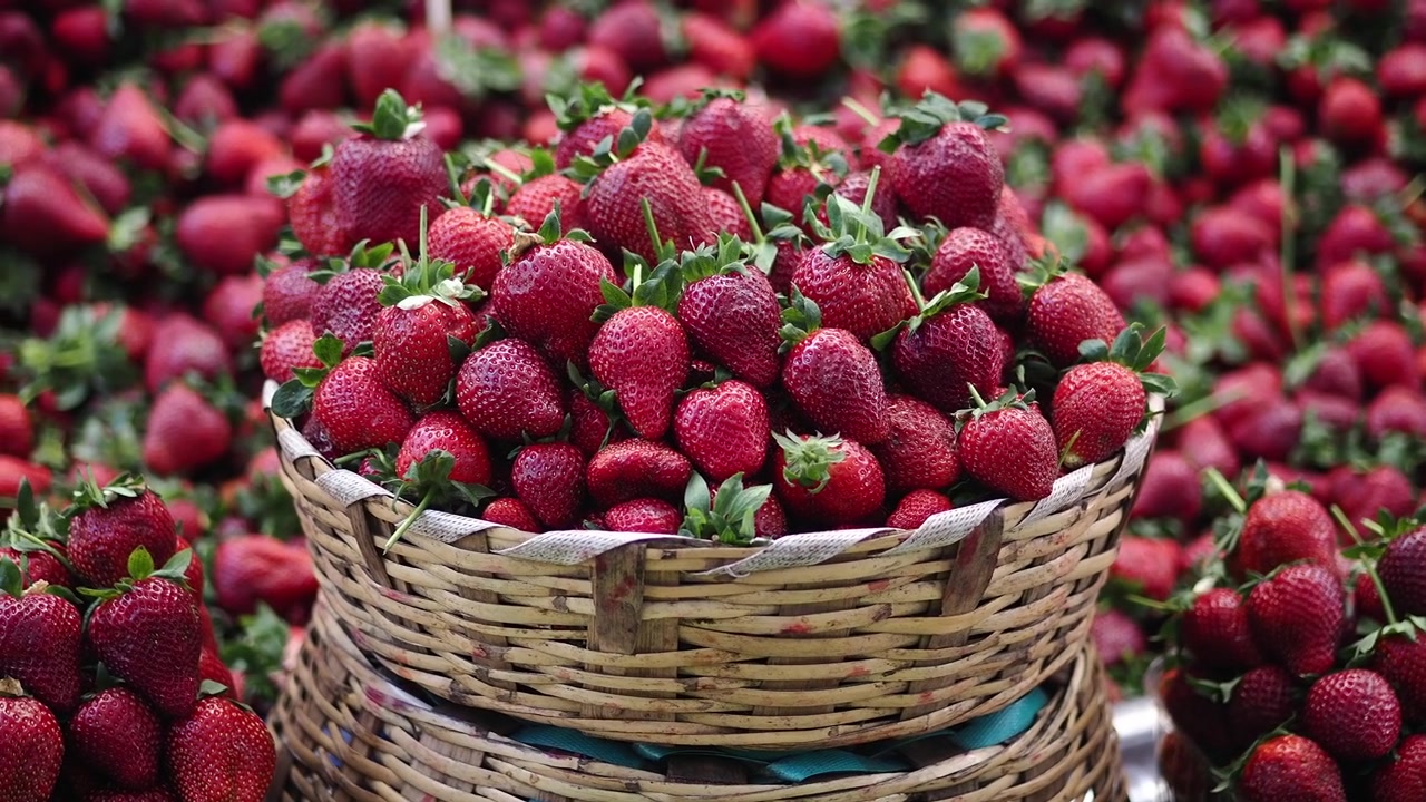 Fresh Red Strawberries in Wicker Baskets at Market