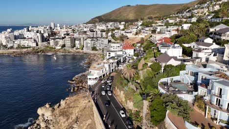 cape town, south africa, aerial drone over a busy coastal road with downtown in the background