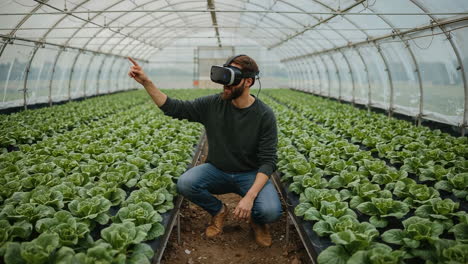 man using vr headset for smart farming in a greenhouse