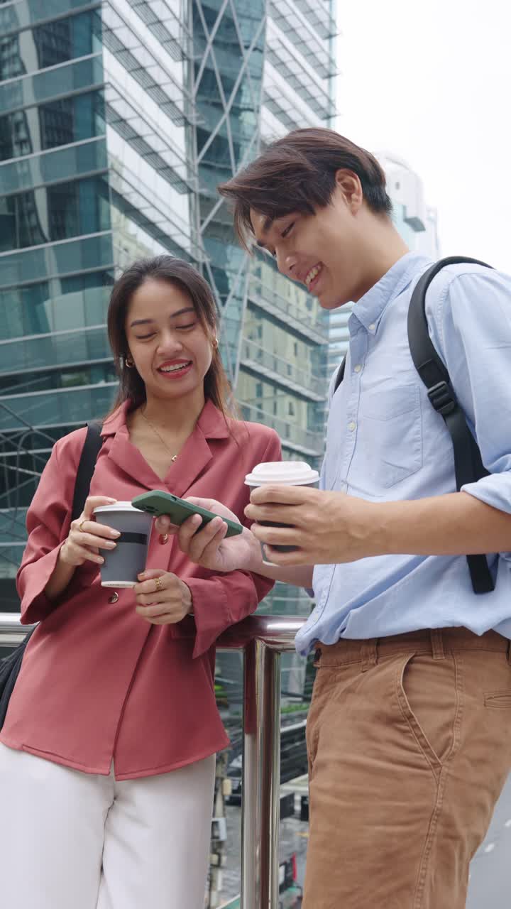 Asian Couple with Coffee and Phone in City