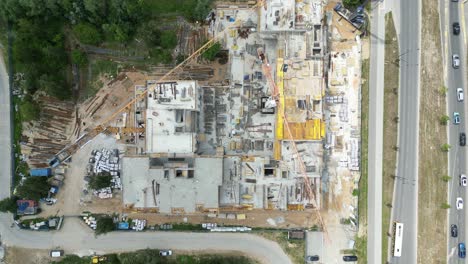 aerial view of construction site with crane and building