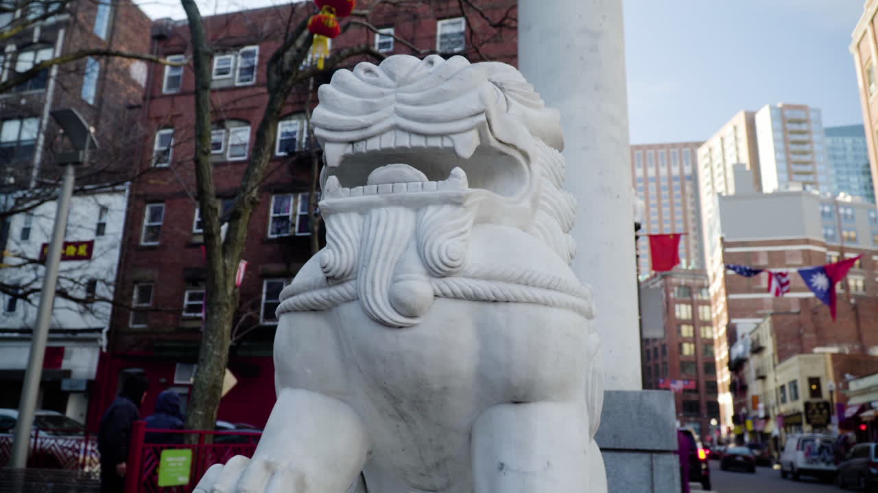 Marble statue of a lion at the Chinatown gate in Boston