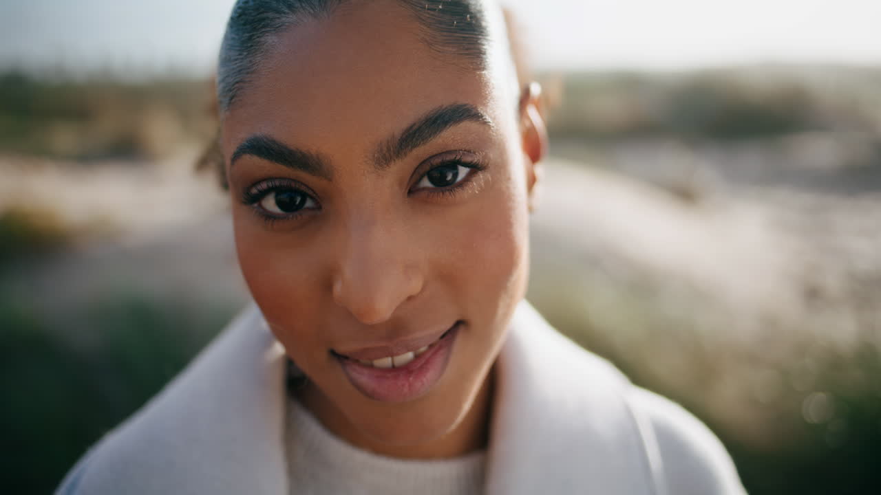 Portrait gorgeous african american looking camera on windy beach. Calm girl rest