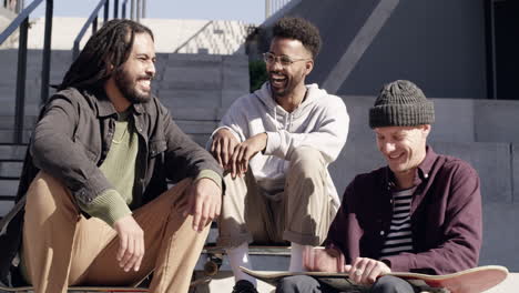 friends enjoying conversation on stairs with skateboards