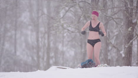 a female ice bather dances to warm up after ice bathing, before toweling dry