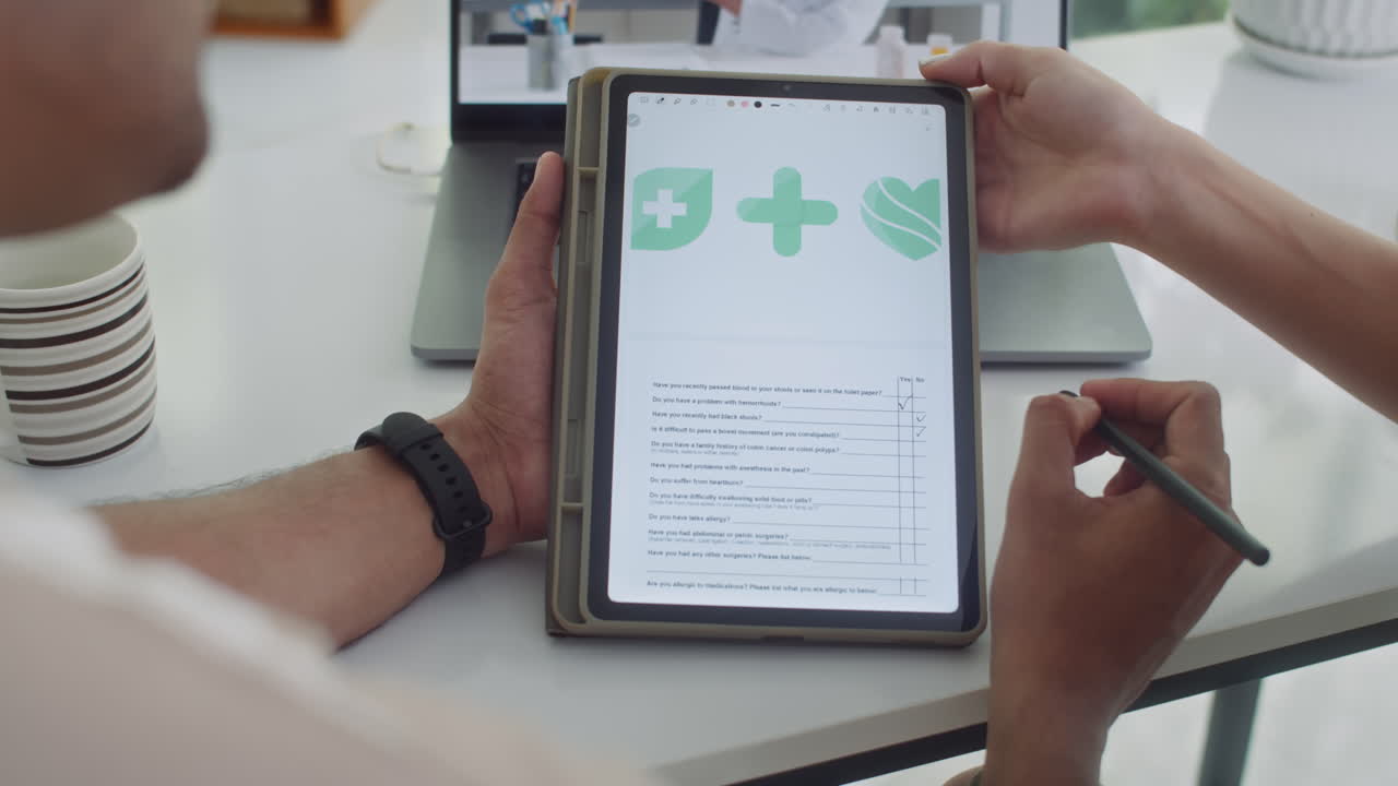 Couple Filling Medical Form on Tablet