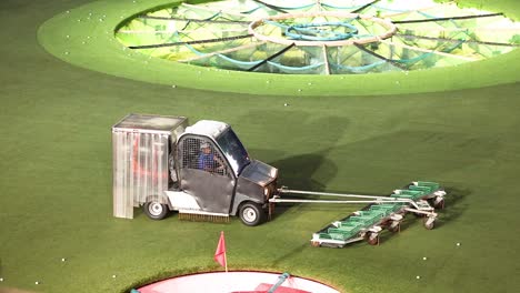 vehicle collecting golf balls on a field