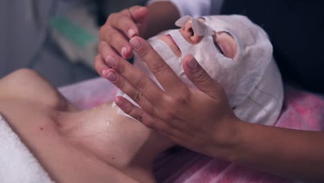 Close-Up-view-of-professional-cosmetologist-applying-special-mask-on-woman's-face-and-neck.-Professional-carboxytherapy-for-young