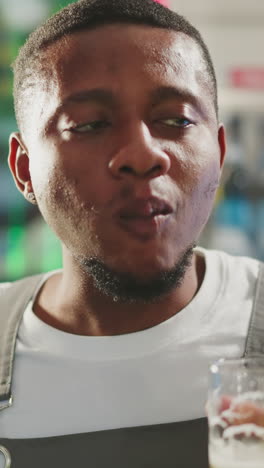 black man degustates beer with satisfaction in pub closeup. african american brewer checkups taste of light alcohol drink working in bar. craft brewery owner