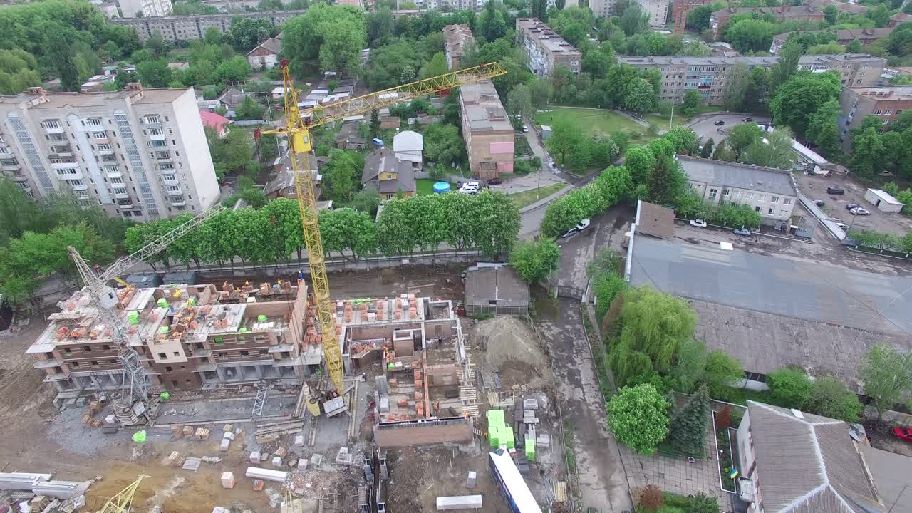 Aerial shot of the construction workers at a building site built in house-building