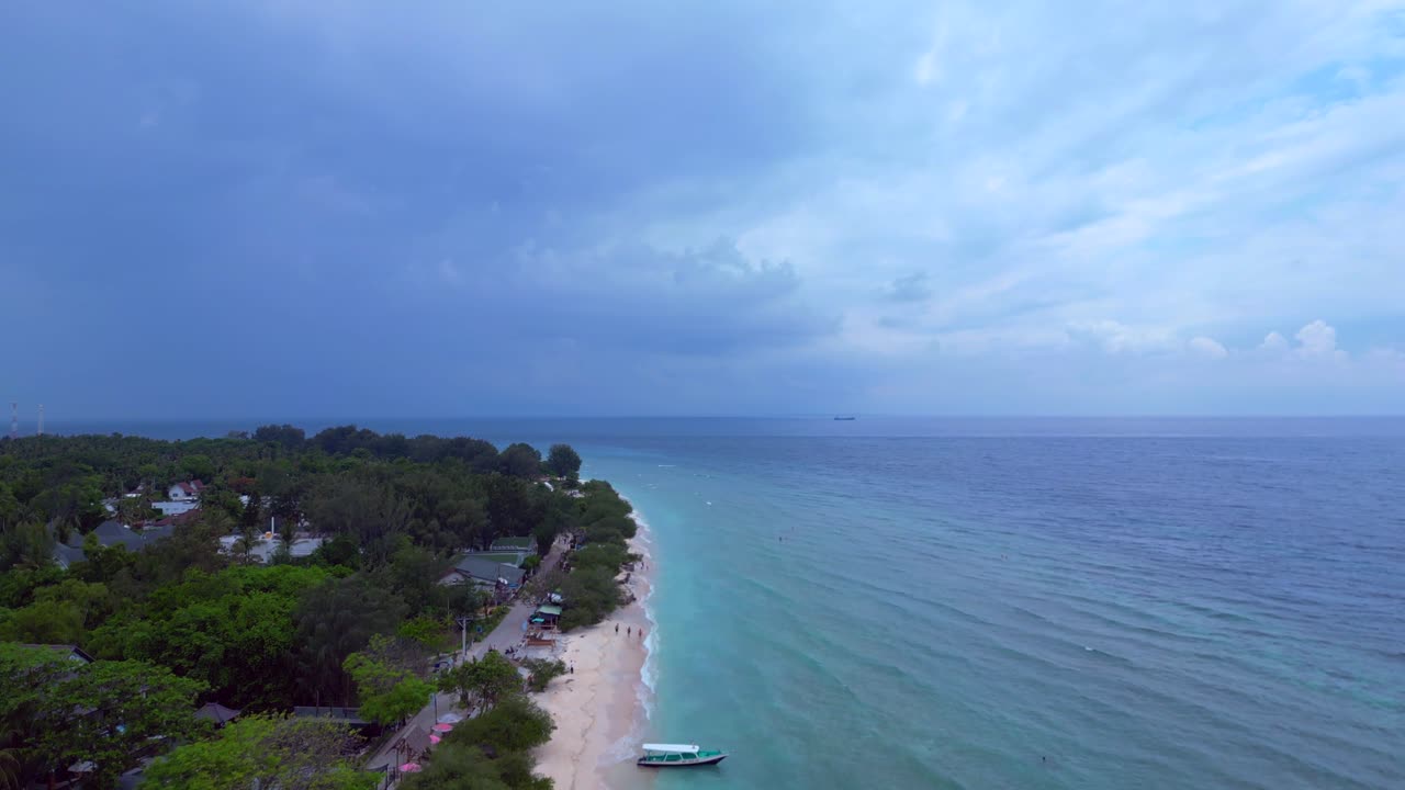 Pantai Pulau Gili Trawangan Indonesia dengan Orang Bersantai dan Berenang di Laut Biru Toska. Pemandangan Udara Menakjubkan, Panorama Menurun dari Drone