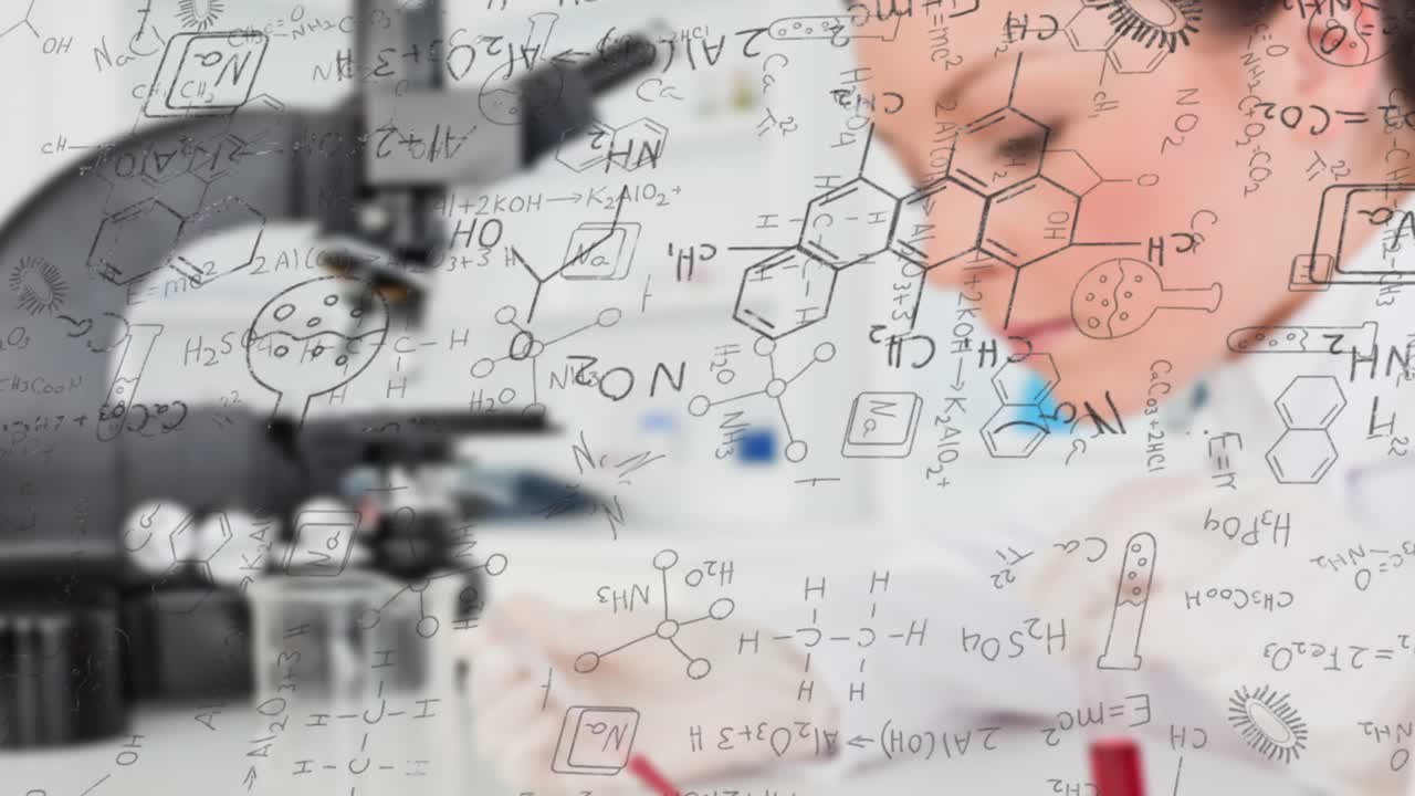 Researcher leaning into microscope, focusing, writing notes behind clear chemistry panel