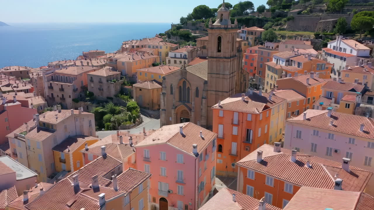 Aerial View of a Picturesque Mediterranean Coastal Town with Colorful Buildings and Church