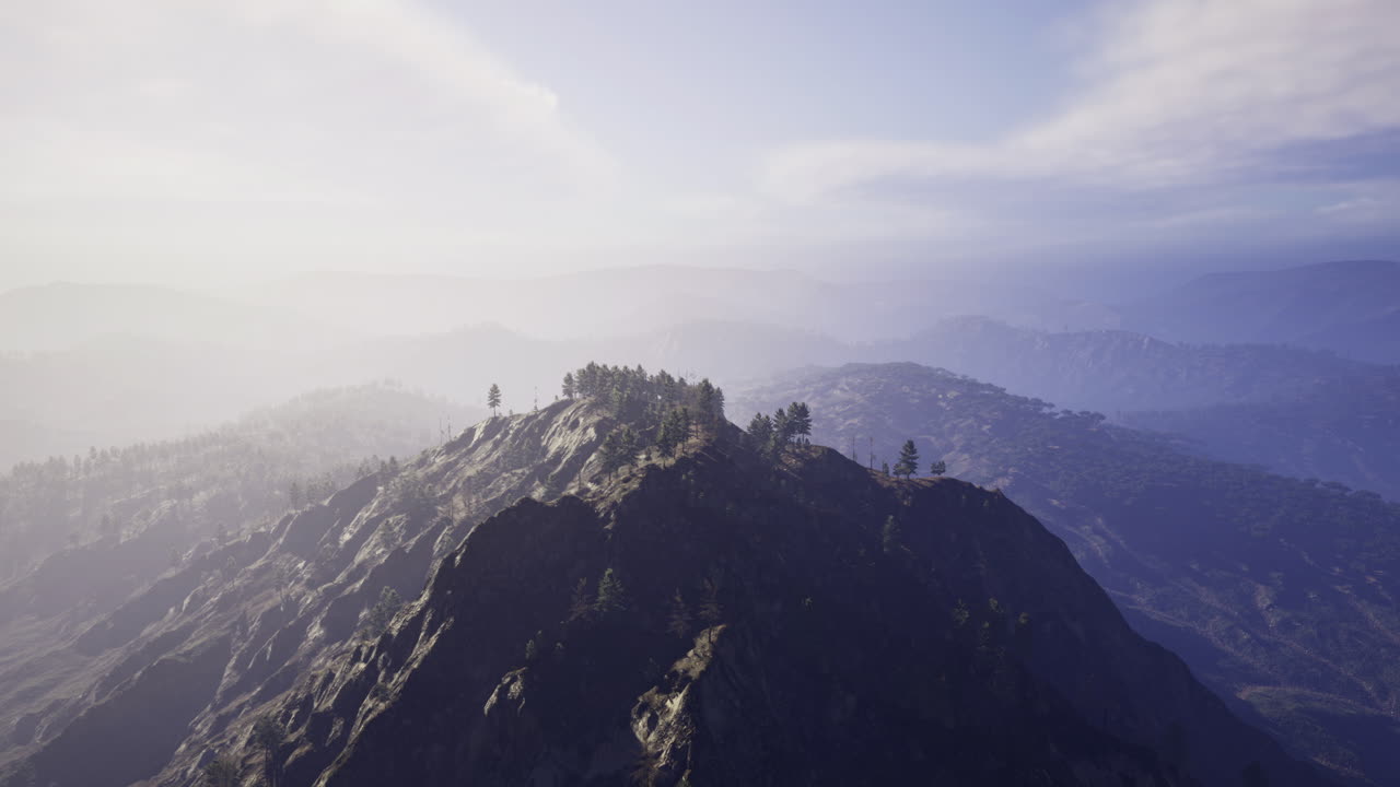 Majestic mountain landscape shrouded in soft mist during golden hour