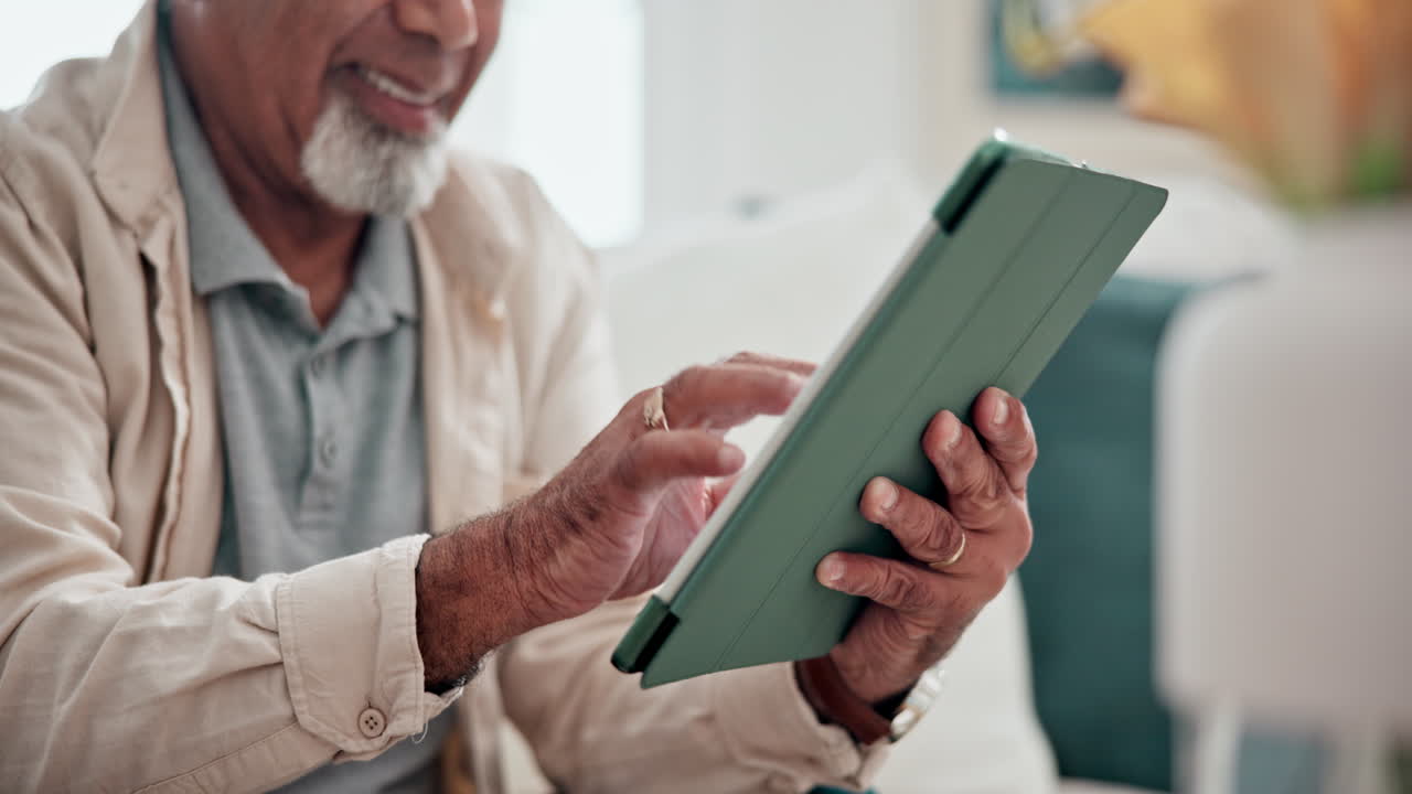 Closeup, hands and man with a tablet on the sofa
