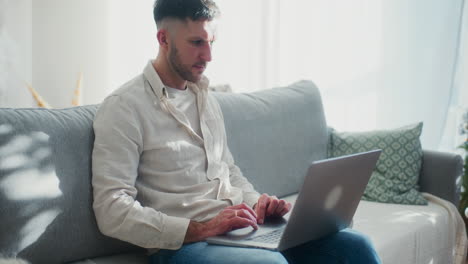 man shopping online on laptop during christmas