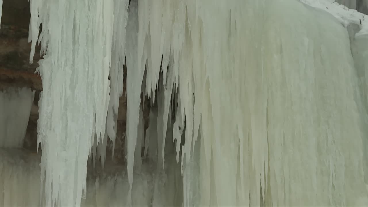 Eben Ice Caves Stalactites And Icicles In Michigan, USA. - tilt down shot