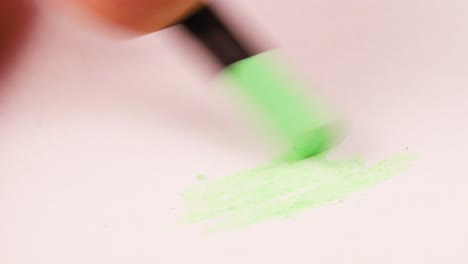 drawing with a very light green crayon on a piece of paper