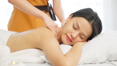 woman receiving a back massage at a spa