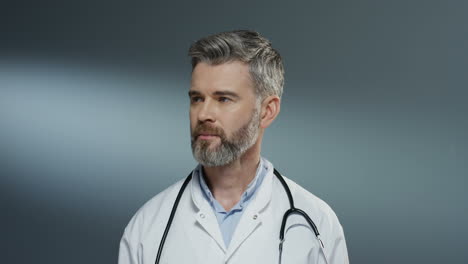 Close-Up-Of-The-Good-Looking-Happy-And-Smiled-Man-Doctor-In-White-Gown-And-With-Stethoscope-On-His-Neck-Looking-Straight-To-The-Camera