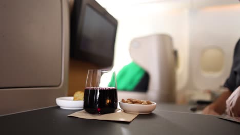 passenger enjoying a snack and drink on flight