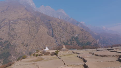 daylight drone shot of phortse village shows dry farms, barren hills, and smoky skies highlighting the urgent need for himalayan nature conservation in nepal tourism