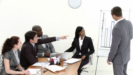 Young-Business-man-giving-a-presentation-to-fellow-employees