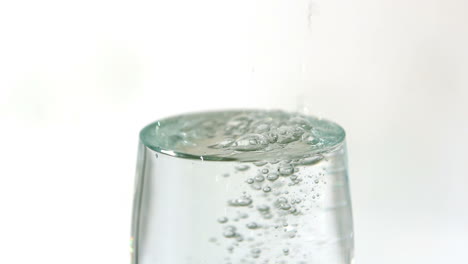 Water-pouring-into-a-glass-overflowing