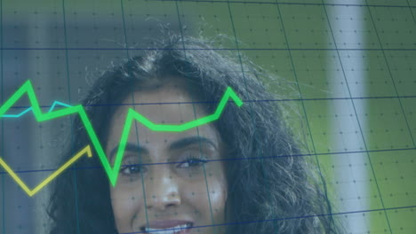 Animation-of-multiple-graphs-and-grid-pattern-over-smiling-biracial-woman-standing-in-office