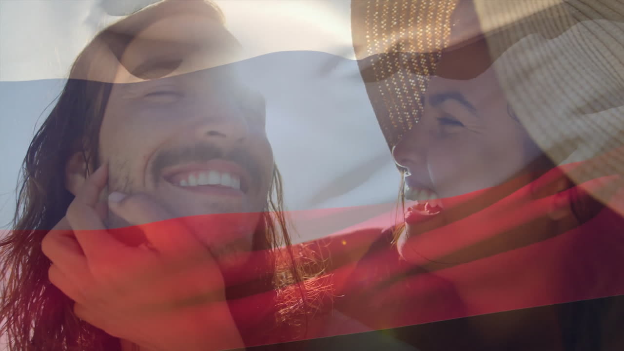 Couple holding translucent flag overlay on sunny day, smiling together outdoors