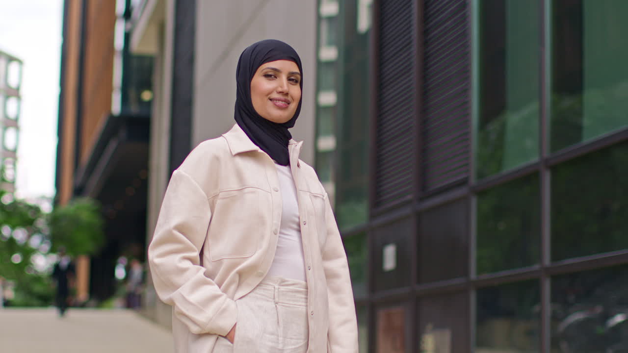 Portrait Of Modern Muslim Businesswoman Wearing Hijab With Business Suit Going To Work Standing Outside Office Building With Hand In Pocket 1