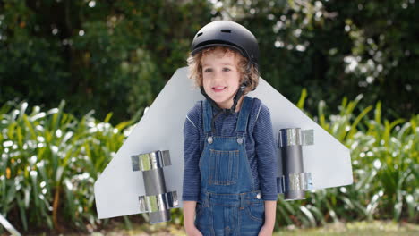 cute little boy wearing toy airplane wings happy child playing game pretending to fly imagining travel freedom having fun outdoors in sunny park enjoying childhood