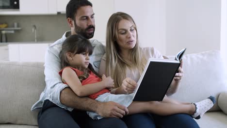 Cheerful-parents-and-little-black-haired-daughter