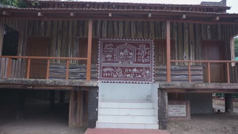 approaching ornate decorated hut with painted designs